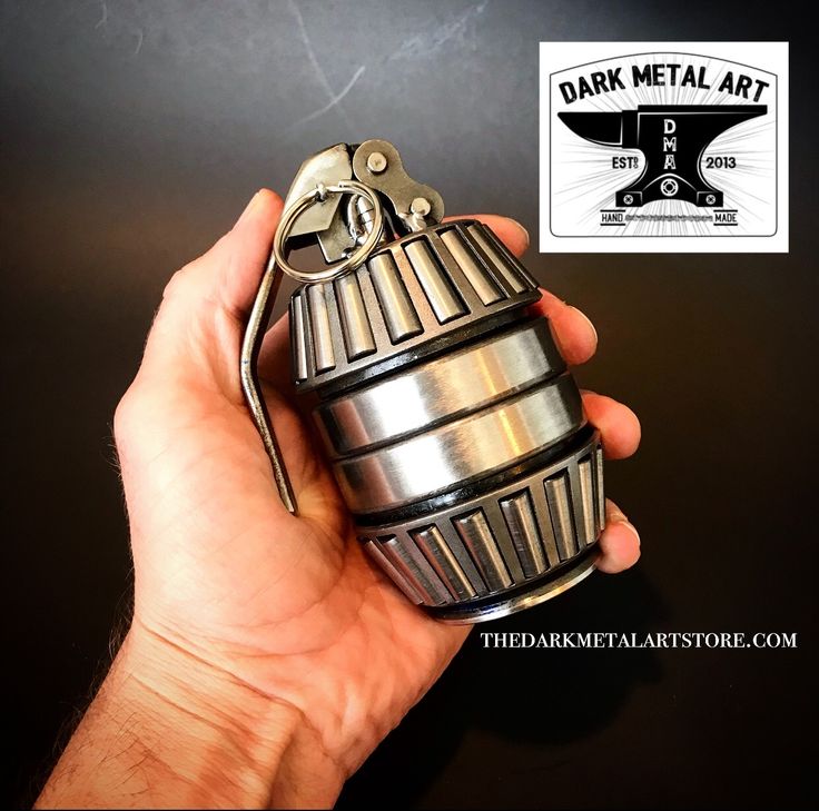 a person holding a metal object in their hand with the label dark metal art on it