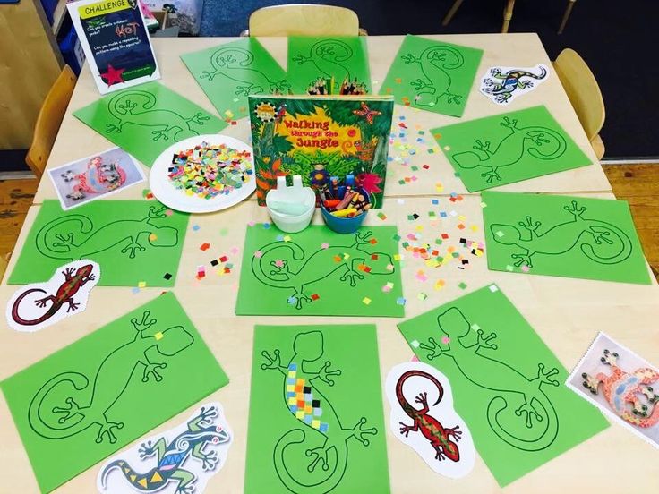 a table topped with lots of green paper cut outs and pictures on top of it