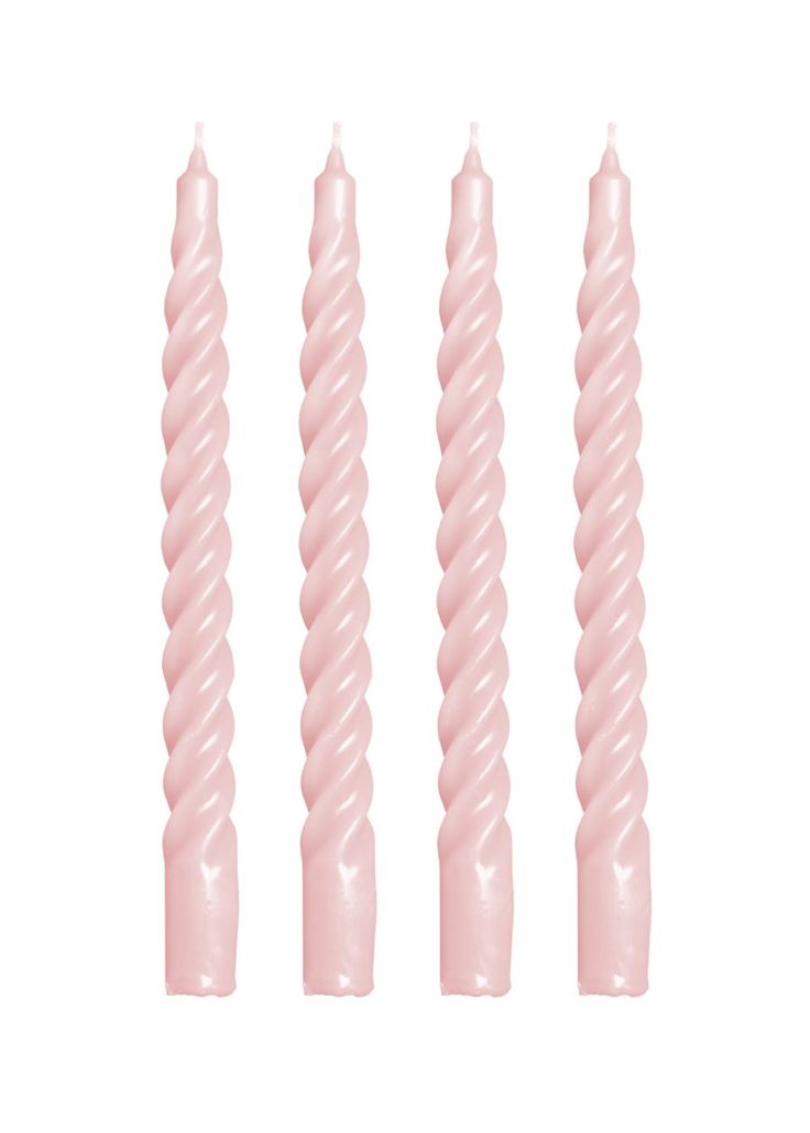 three pink candles sitting next to each other