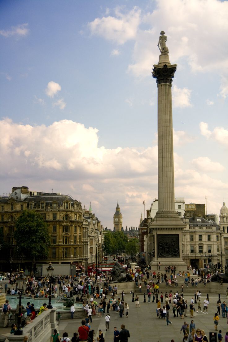 a crowd of people standing around a tall monument