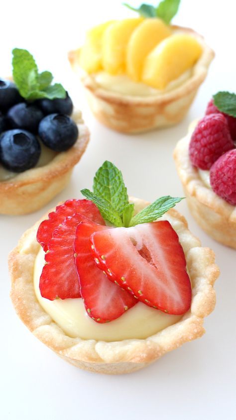 four small tarts with fruit on top