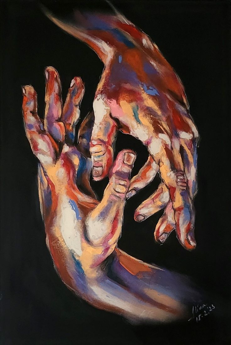 two hands reaching out to each other with colored paint all over them on a black background