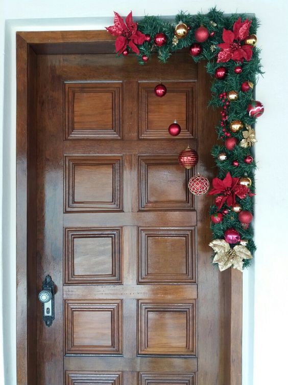 a wooden door decorated with christmas decorations