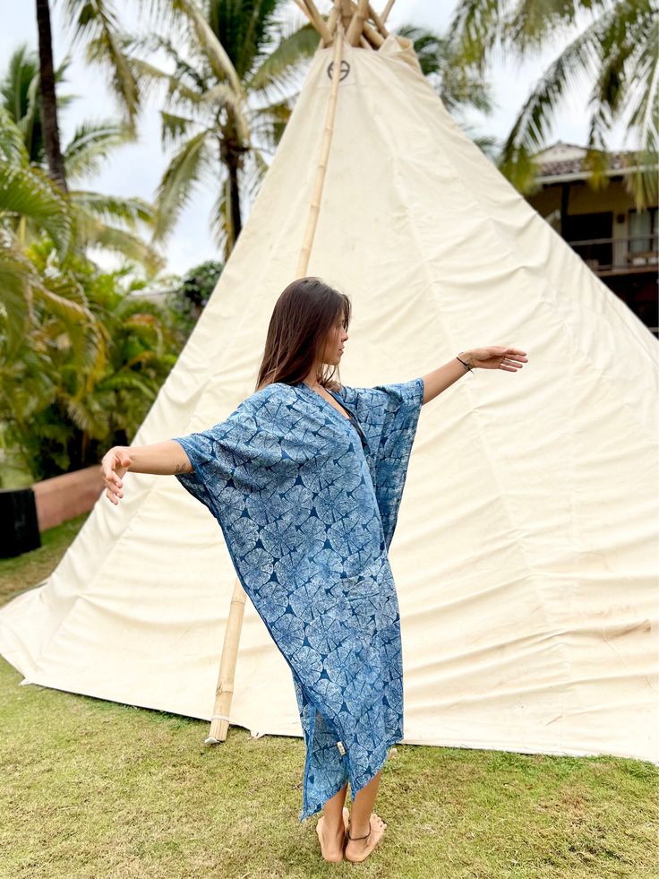 Beautiful Indigo 100% Cotton Caftan Dress with Japanese style print. This dress with an incredible crisp print is an amazing addition to any bohemian or spiritually inclined wardrobe. Perfect morning festival dress or a special ritual attire for an intentional gathering. Size: One sizeOveral Length: 46 in. Overal Width: 44 in.Material: 100% cotton, indigo dyed and hand-block printed by our friends, the local artisans in Bagru village, Rajasthan, India. It is a dress that can be used for gatherin Traditional Summer Batik Print Kimono, Spring Bohemian Kaftan With Batik Print, Festival Beachwear Kaftan With Kimono Sleeves, Spring Bohemian Batik Print Kaftan, Bohemian Batik Print Maxi Dress For Festival, Festival Batik Print V-neck Maxi Dress, Festival V-neck Maxi Dress With Batik Print, Bohemian Block Print Kimono For Festivals, Bohemian Batik Print Kaftan For Vacation