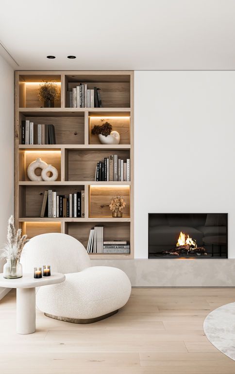 a living room filled with furniture and a fire place in the middle of the room