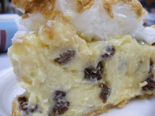 a piece of pie on a plate with ice cream and raisins around it