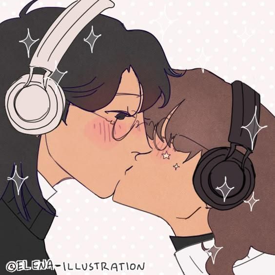 a couple kissing each other with headphones on