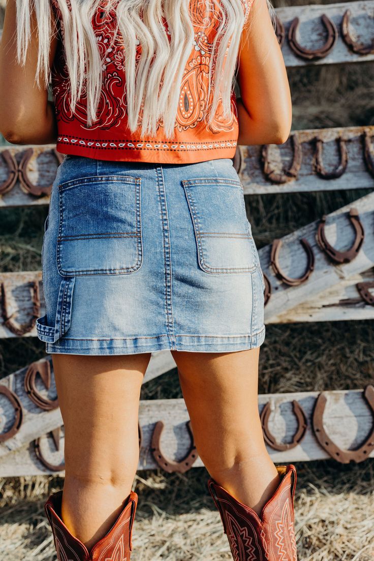 Introducing the Shanelle Skirt - a high rise western skirt with a medium wash and comfortable stretch for all-day wear. Its mini length and big pocket add convenience and style, while the belt loop detail adds a touch of flair. Upgrade your denim game now! Kiah is wearing size small paired with The Paisley Vest and Pinup Cowgirl Top and Ariat Casanova Boots Medium Wash Mini Skort With Pockets, Summer Medium Wash Denim Skirt With Belt Loops, Mini Denim Skirt With Pockets In Medium Wash, Casual Light Wash Bottoms For Rodeo, Medium Wash Denim Bottoms For Rodeo, Medium Wash Denim Mini Skirt With Pockets, Fitted Casual Medium Wash Cargo Skirt, Medium Wash Mini Skirt With Pockets, Casual High Rise Cargo Skirt In Medium Wash