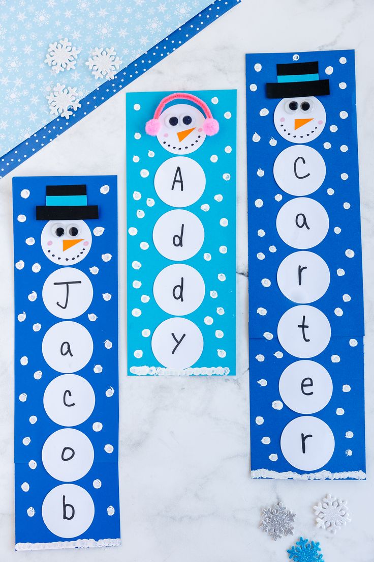 two snowman themed bookmarks with the words abc, q and d on them