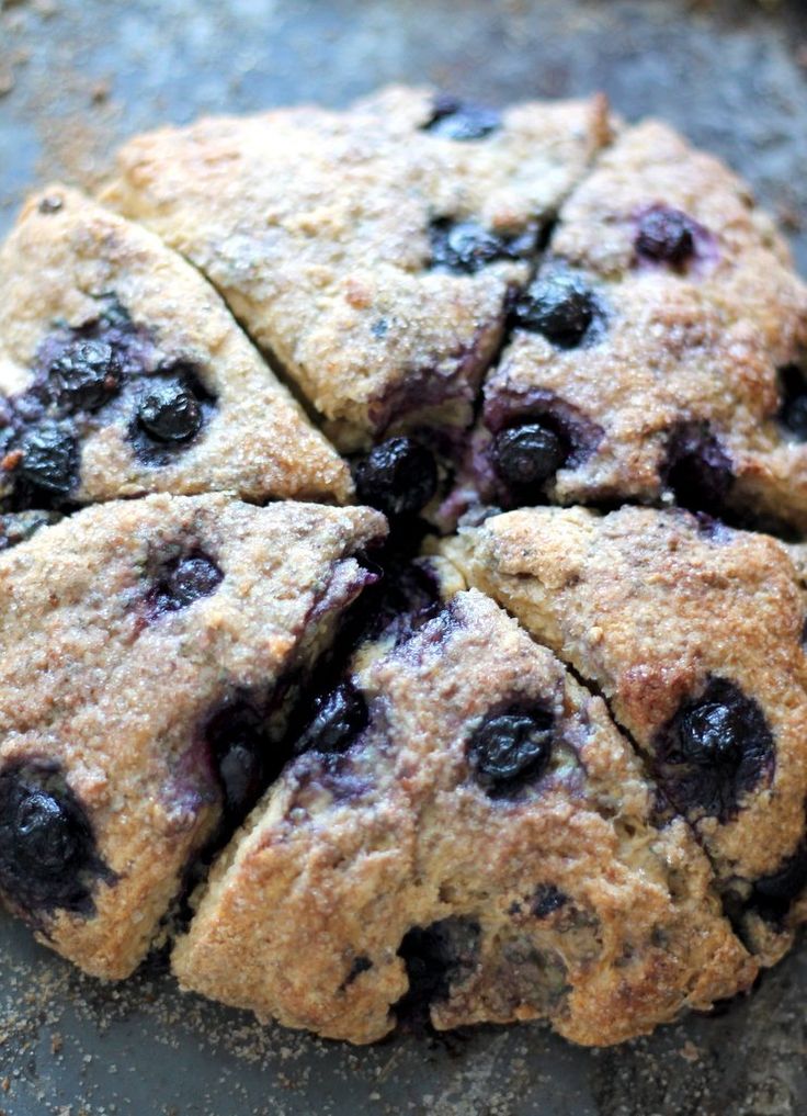 blueberry scones cut into eight pieces on top of a baking pan with one slice taken out