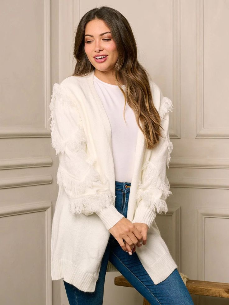 Get cozy and stylish with our Long Sleeve Open-Front Boho Fringe Cardigan! Perfect for any occasion with its unique boho fringe design and comfortable long sleeves. Stay trendy and warm in this must-have addition to your wardrobe. (Bonus points for pairing with your fave boots and a hot cocoa in hand!) * Color: White * 52% Acrylic 28% Polyamide 20% Spandex * Hand Wash * Model is wearing size S | Length: 29" Bust: 42" Waist: 21" White Long Sleeve Outerwear With Tassels, Spring Fringe Long Sleeve Cardigan, Winter Outerwear With Tassels And Long Sleeves, Winter Long Sleeve Outerwear With Tassels, Chic Winter Fringe Outerwear, Spring Long Sleeve Fringe Cardigan, Knit Fringe Outerwear For Fall, Chic Fringe Cardigan, Knit Outerwear With Fringe For Fall