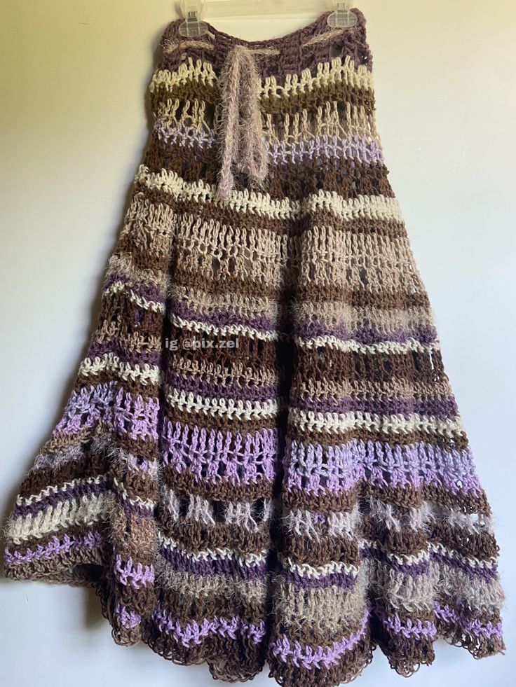 a crocheted skirt hanging on the wall