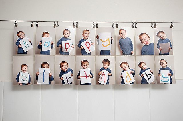 a group of children holding up pictures with the letters p and o on them hanging from hooks