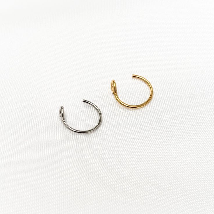 Add a little shine in an unexpected place with our handmade hoop nose rings/ earrings. No piercing needed for this nose cuff/ ear cuff. So comfortable you forget it's even there! ✔ Does Not Tarnish ✔ Hypoallergenic ✔ Water Resistant ✔ Quality Guaranteed ✔ Handmade SIZE: adjustable NOTE: this is a fake nose ring/earring, there is no piercing required. Adjustable Minimalist Hoop Ear Cuff, Adjustable Round Ear Cuff For Everyday Wear, Adjustable Small Hoop Single Ear Cuff, Adjustable Minimalist Small Hoop Ear Cuff, Minimalist Adjustable Small Hoop Ear Cuff, Adjustable Minimalist Round Ear Cuff, Minimalist Adjustable Round Ear Cuff, Hoop Nose Rings, Lip Cuffs