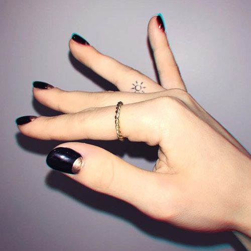 a woman's hand with two rings on it