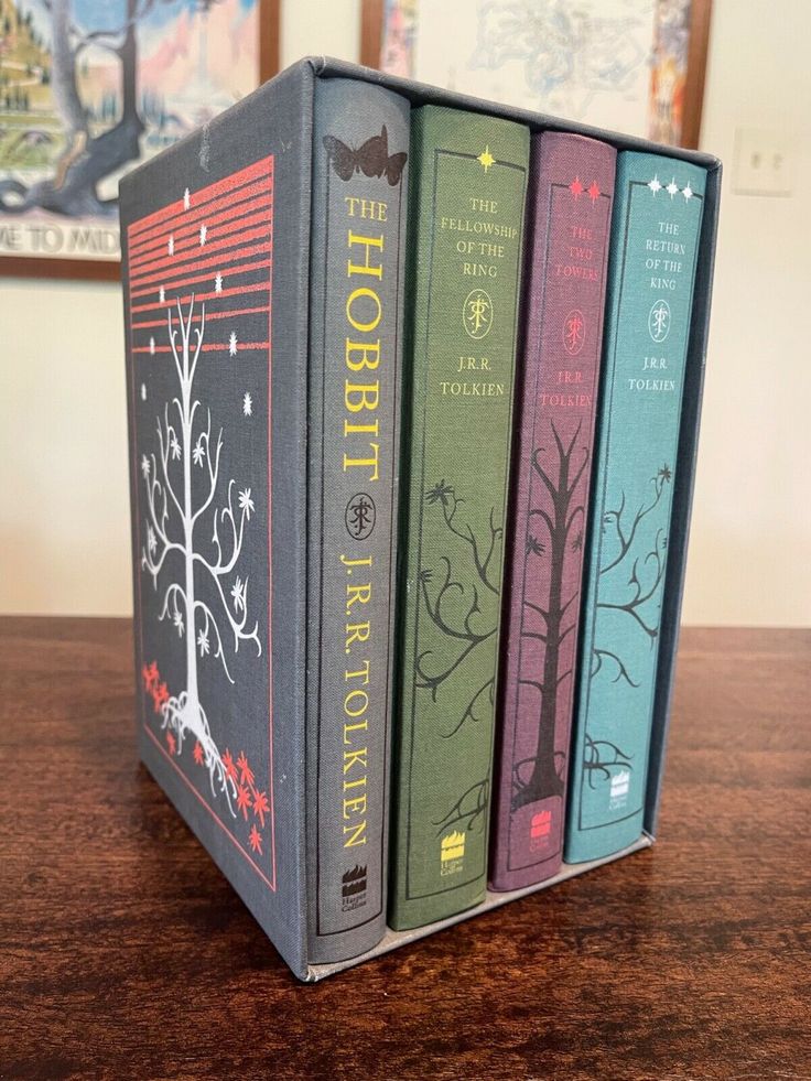 three books sitting on top of a wooden table