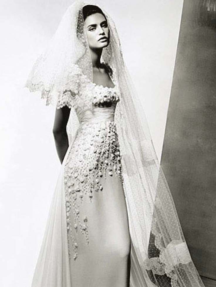 a black and white photo of a woman in a wedding dress