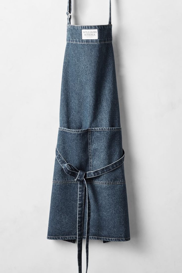 a denim apron hanging on the wall