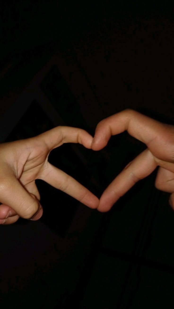 two hands making a heart shape with their fingers