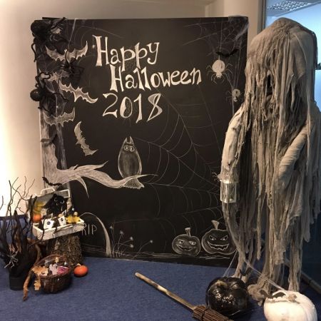 halloween decorations are on display in front of a blackboard