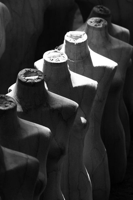 black and white photograph of sculptures made out of clay