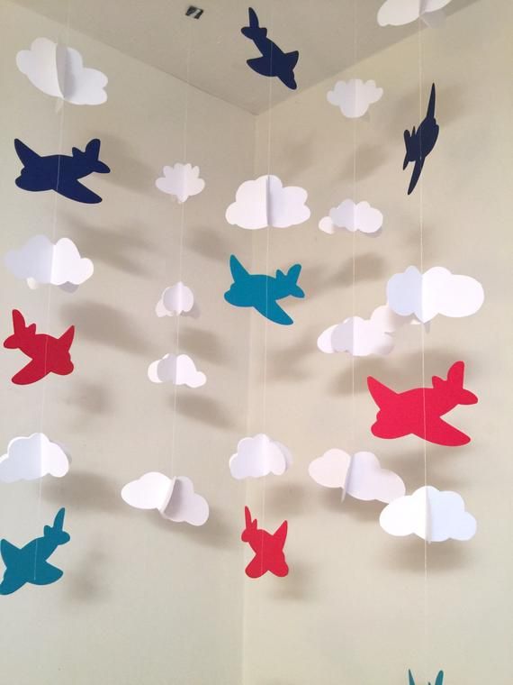 paper birds and clouds hanging from the ceiling