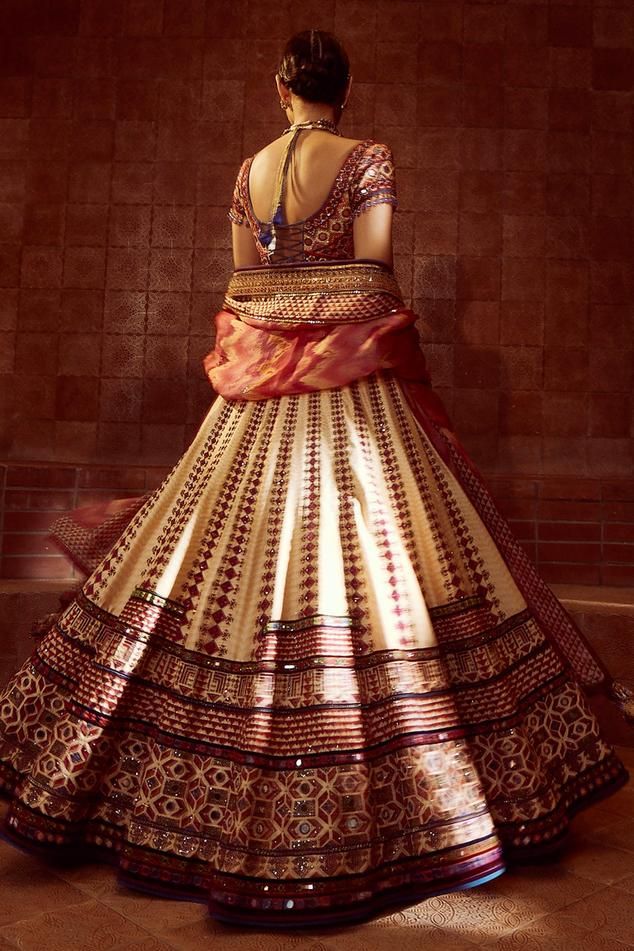 Multicoloured kalidar lehenga inspired by tribal patchwork and two stylised patkas in the front that is highlighted with intricate zardozi and aari embroidery and mirrorwork. Comes with mirror and resham-embroidered blouse which is embellished with stone fringes. Paired with a hand-printed dupatta with matching borders.
Component: 3
Pattern: Embroidered
Type Of Work: Mirror,Zardozi,Aari, Tribal Patchwork 
Neckline: Notched
Sleeve Type: Short Sleeves
Fabric: Lehenga-Silk Dupion , Blouse -Cambric, Bohemian Silk Anarkali Set For Wedding, Multicolor Tussar Silk Sets For Wedding, Traditional Art Silk Choli For Transitional Season, Traditional Multicolor Tussar Silk Choli, Ceremonial Floor-length Sets With Traditional Patterns, Bohemian Floor-length Lehenga For Traditional Ceremonies, Wedding Multicolor Tussar Silk Lehenga, Bollywood Style Multicolor Tussar Silk Choli, Bohemian Chanderi Choli For Wedding