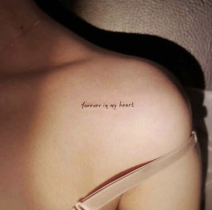 a woman's back with the words forever is my heart written on it