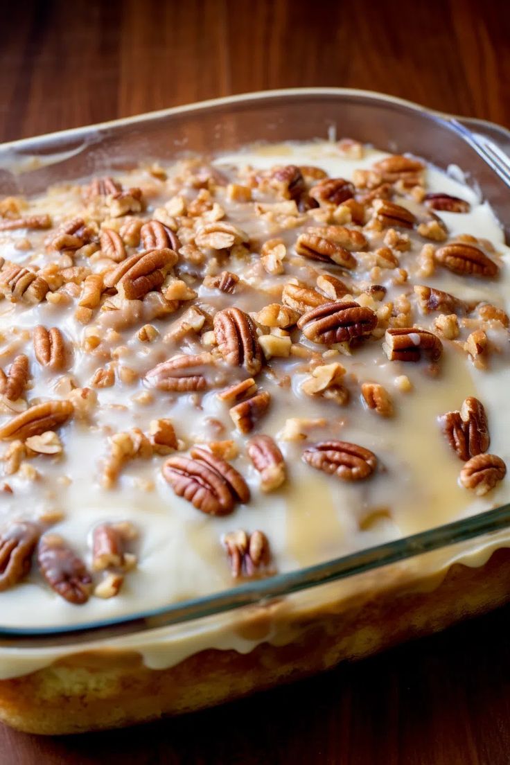 a glass dish filled with cream and pecans