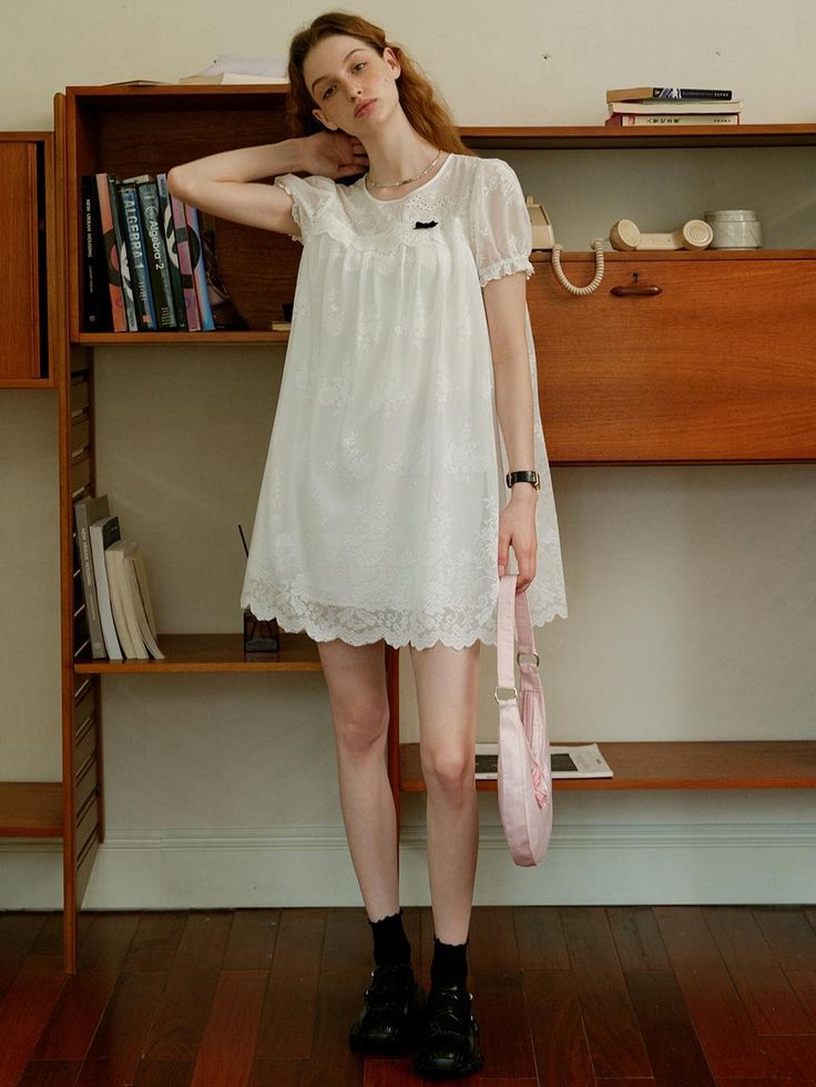 This product, the Cest Baby Doll Lace Dress, embodies a sweet and youthful charm with its delicate lace detailing. The flowy and loose fit provides both comfort and a whimsical aesthetic, perfect for a casual day out or a special occasion. The intricate lace design adds an element of sophistication to this playful dress. - This dress features a baby doll silhouette, offering a relaxed and airy fit.- The lace detailing throughout the dress enhances its delicate and feminine appeal.- Puff sleeves add a touch of vintage charm, complementing the overall design.- The scalloped lace hemline adds a refined finishing touch.- Made from soft, breathable fabric, it ensures comfort while maintaining style. Spring Mini Lace Dress With Lace Collar, Feminine Lace Patchwork Mini Dress With Short Sleeves, Feminine Mini Dress With Lace Patchwork, Feminine Short Sleeve Mini Dress With Lace Patchwork, Spring Delicate Lace Mini Dress For Daywear, Spring Mini Dress With Delicate Lace For Daywear, Spring Mini Dress With Lace Collar For Daywear, Spring Daywear Mini Dress With Delicate Lace, Spring Day Lace Dress With Delicate Details