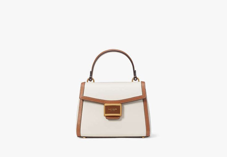 Our Katy bag gets a new look with a polished top-handle design. Done in colorblocked textured leather it's the go-to bag for days when you want to feel perfectly put together. | Kate Spade Katy Colorblocked Small Top-Handle Bag, Halo White Kate Spade Shoulder Bag With Gold-tone Hardware, Chic Medium Satchel With Top Carry Handle, Chic Medium Bag With Gold-tone Hardware, Chic Medium Satchel With Detachable Handle, Modern Medium Bags With Detachable Handle, Modern Medium Shoulder Bag With Detachable Handle, Modern Medium Bag With Detachable Handle, Kate Spade Everyday Top Handle Satchel, Kate Spade Top Handle Everyday Satchel