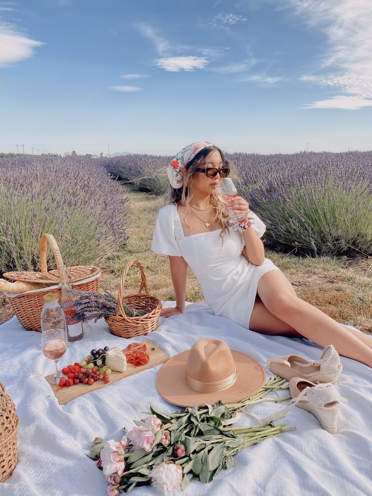 a woman sitting on top of a white blanket