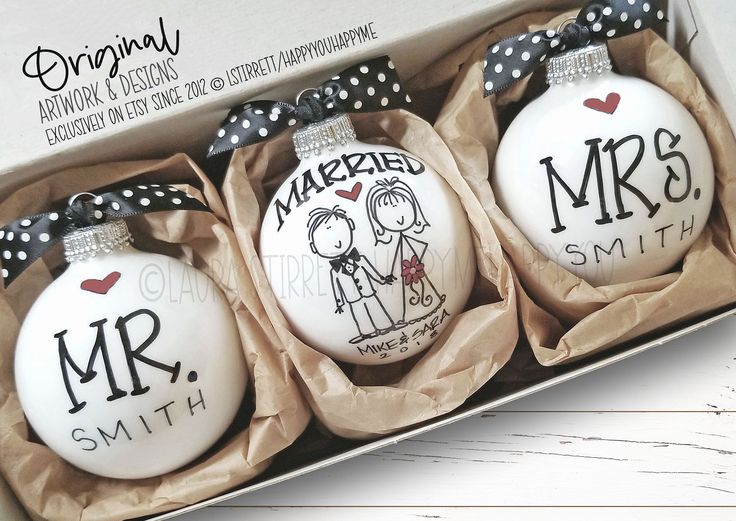 three personalized christmas ornaments in a box