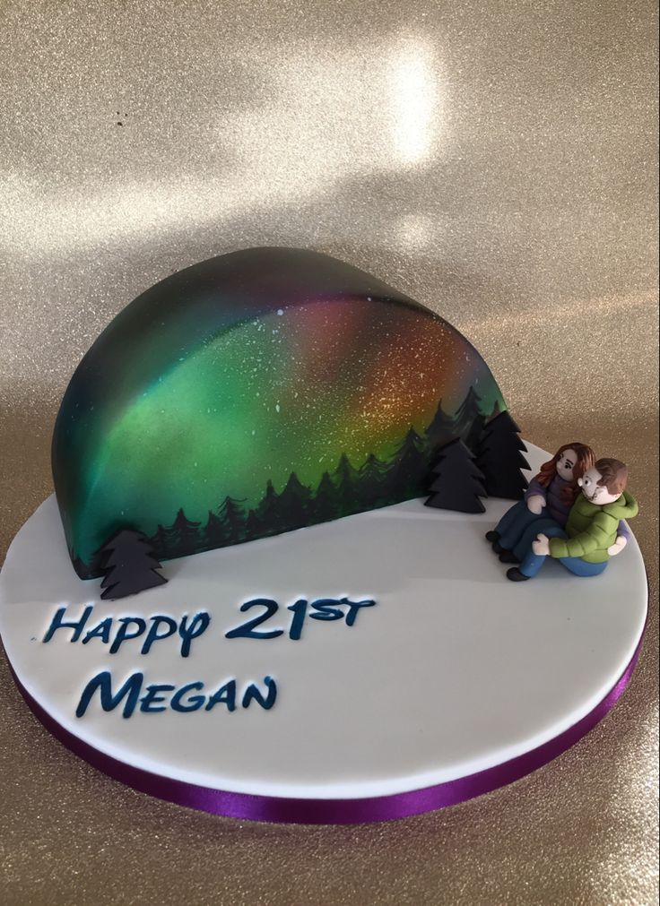 a birthday cake with an image of a man and woman hugging under the aurora bore