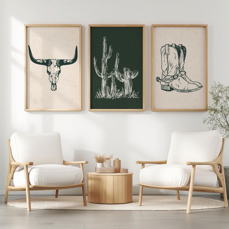 two chairs and a table in a room with three pictures on the wall above them