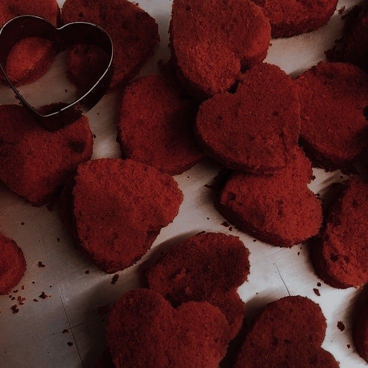 red heart shaped cookies are on the table