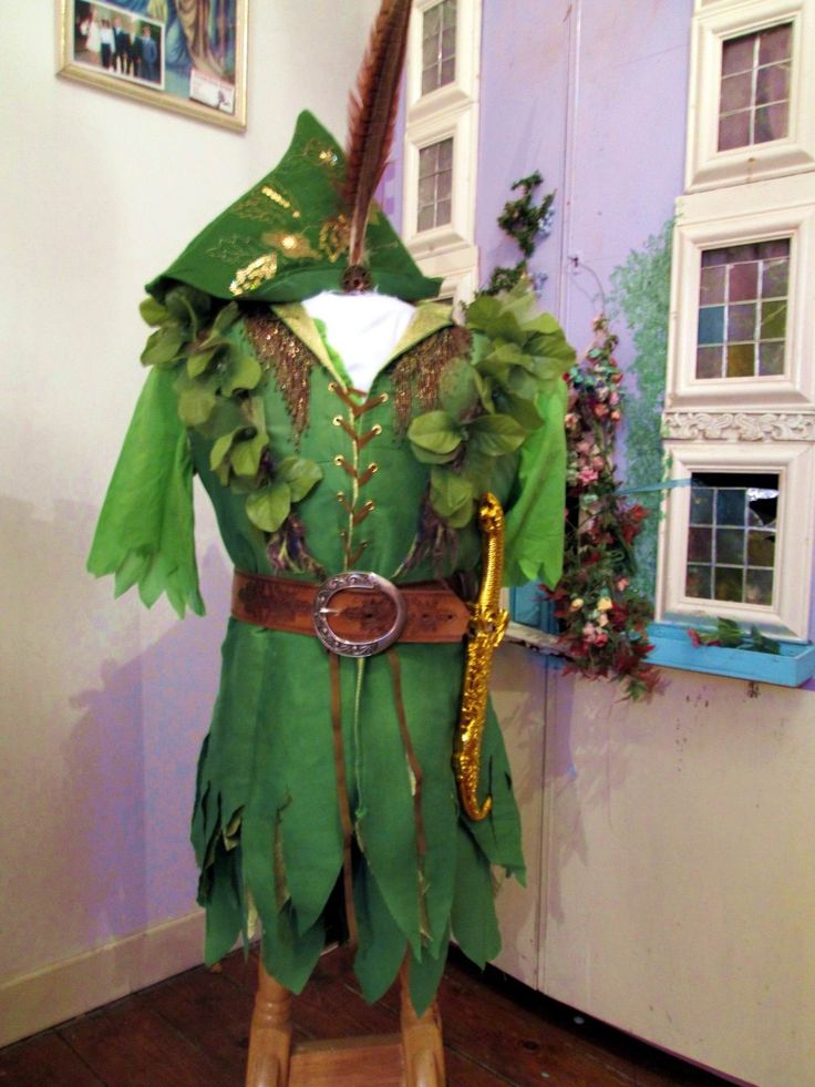 a green costume on display in a room