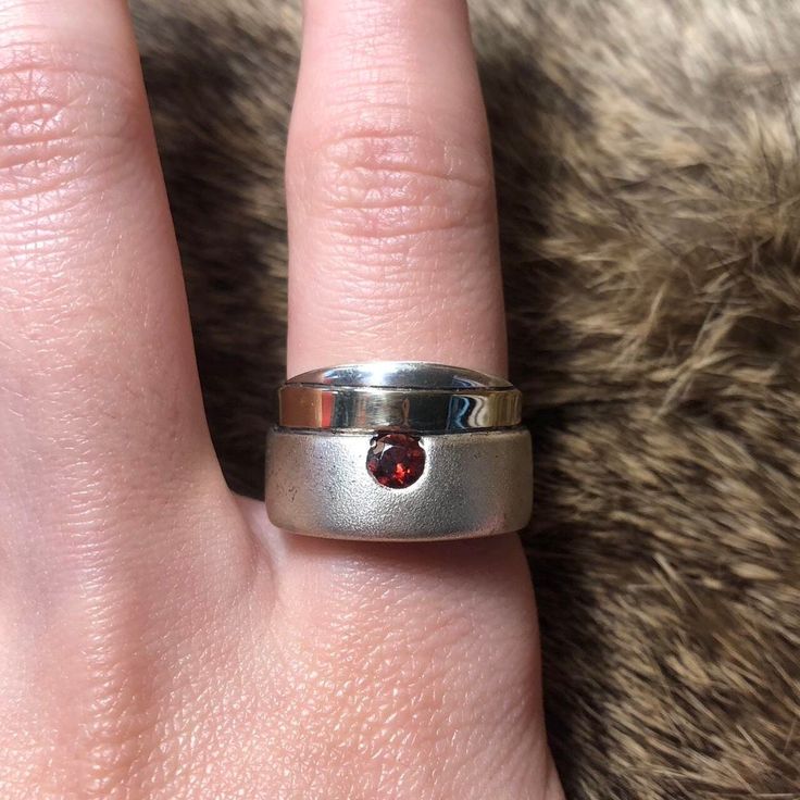 Vintage Flli Menegatti? sterling silver and 14k minimalist garnet ring. Chunky matte sterling ring with band of 14k gold and deep red faceted garnet. Stamped 925 585 (14k), signed VI, size 8, 8.71g. Modern Silver Ruby Ring With Polished Finish, Sterling Silver Rings With Tension Setting For Everyday, Modern Sterling Silver Ruby Ring For Anniversary, Modern Garnet Jewelry, Modern Sterling Silver Ruby Ring, Formal Stackable Ruby Ring In Sterling Silver, Silver Polished Garnet Jewelry, Modern Garnet Rings For Anniversary, Silver Garnet Jewelry With Polished Finish