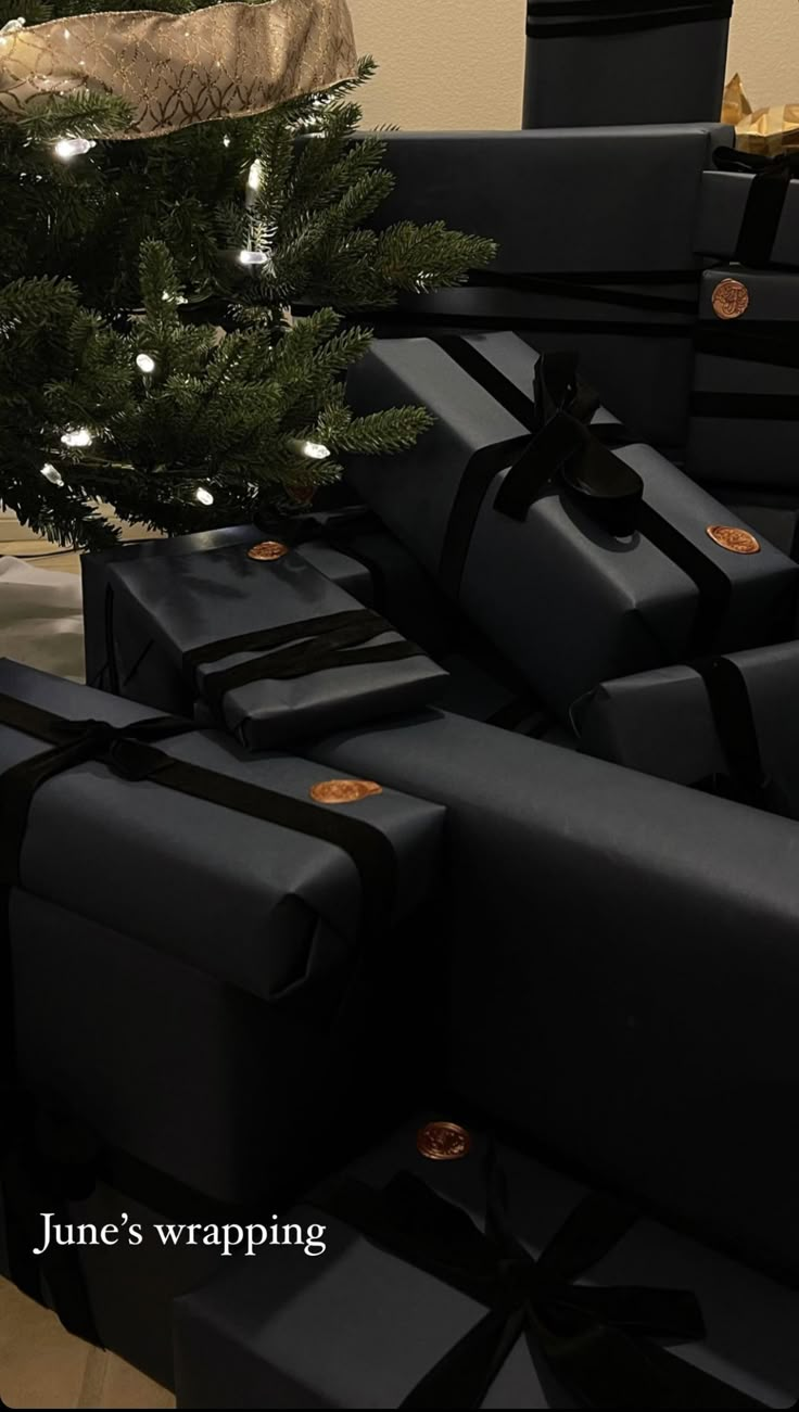 presents under the christmas tree are wrapped in black paper and tied with string lights on them