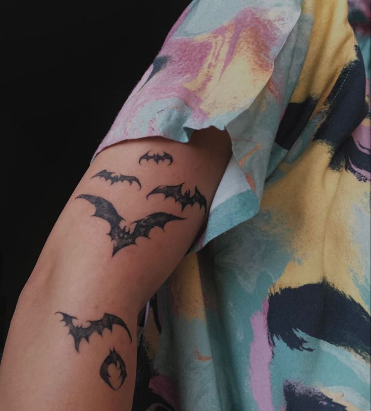 a person with a bat tattoo on their arm