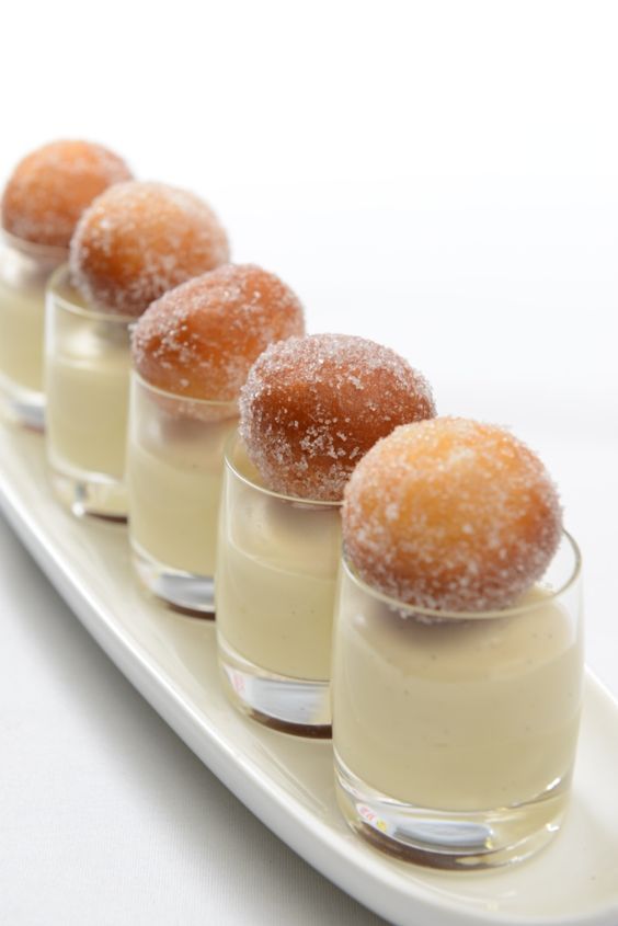 small desserts are lined up on a white plate