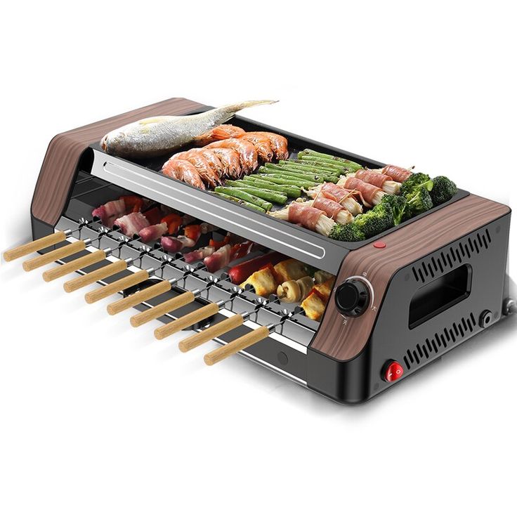 an electric grill with different foods cooking on it