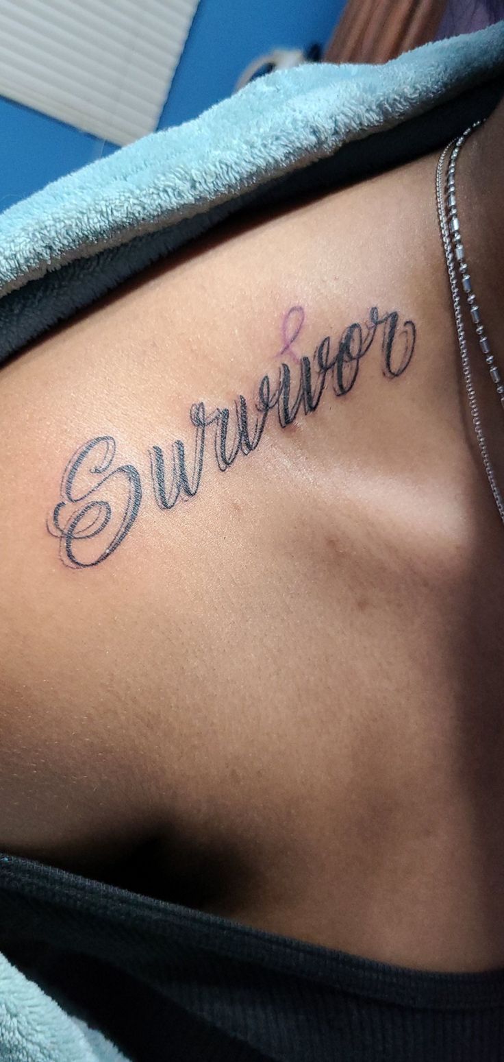 a woman's stomach with the word survivor tattooed on her left side ribcage