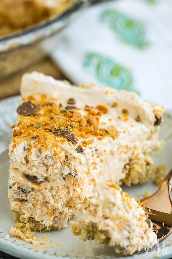 a close up of a piece of cake on a plate with a spoon in it