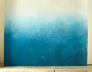 an empty room with a blue and white painting on the wall