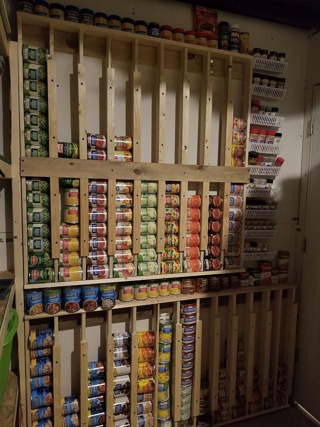 the shelves are filled with canned food