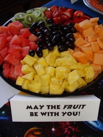 a plate full of fruit with a sign that says may the fruit be with you