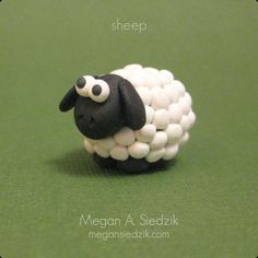 a sheep made out of marshmallows sitting on top of a green surface