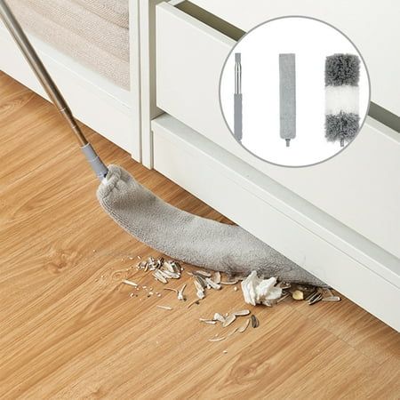 an image of a cleaning mop on the floor in front of a cabinet door