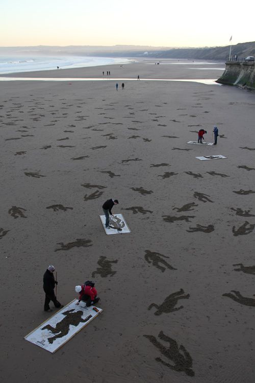 several people are on the beach with their surfboards